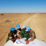 L’équilibre entre standardisation et adaptations des opérations de paix – Comment éviter la surcharge des mandats ? Visite du camp de Smara. Des casques bleus de l'ONU originaires du Ghana, de France, du Bangladesh et de Mongolie consultent une carte pour s'orienter dans la vaste zone de Smara. Crédits photo : Martine Perret/ONU.